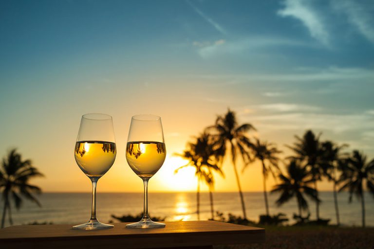 wine glasses sunset in background sundial sanibel gulf of mexico