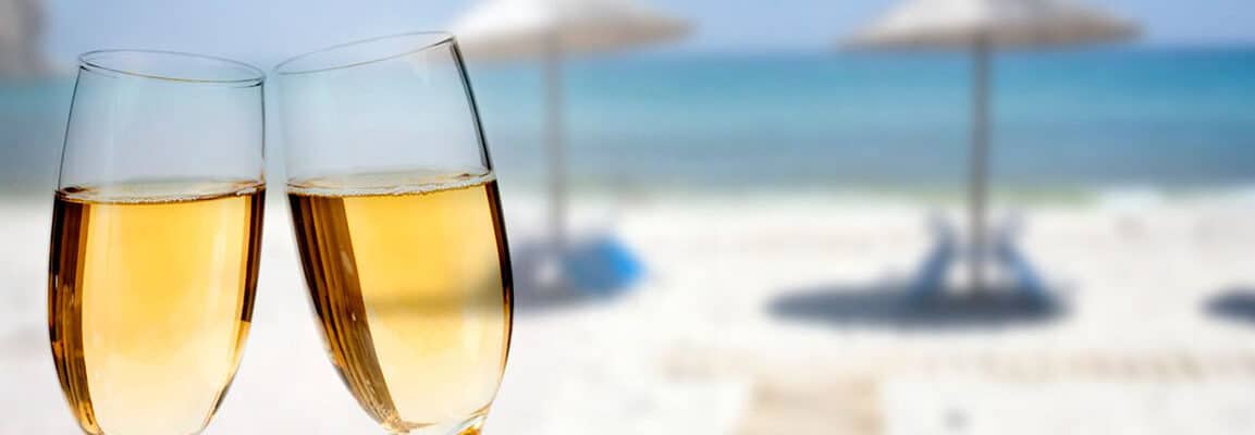 white wine cheers on the beach