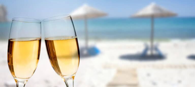 white wine cheers on the beach