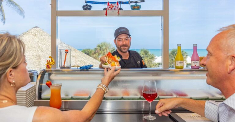 man and woman at sushi bar shima sundial overlooking gulf crop