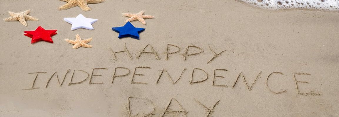 happy independence day written in sand