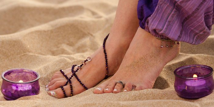 Feet on a candlelit beach.