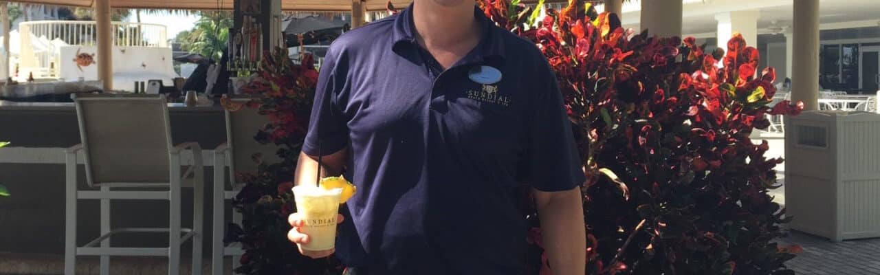 best-bartender sanibel island sundial holding tropical cocktail