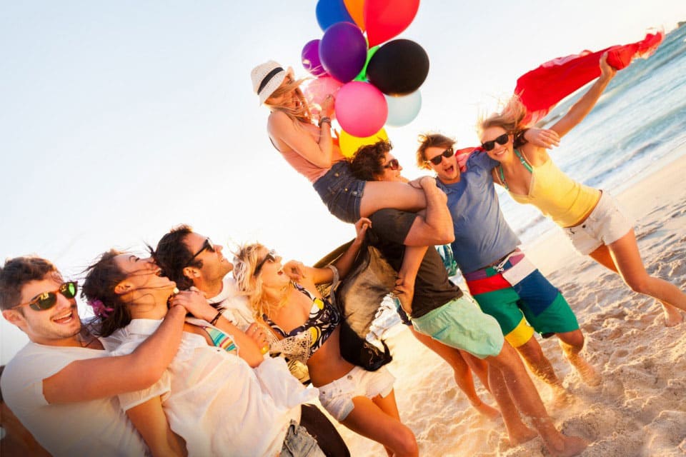 young people fun on the beach balloons ocean