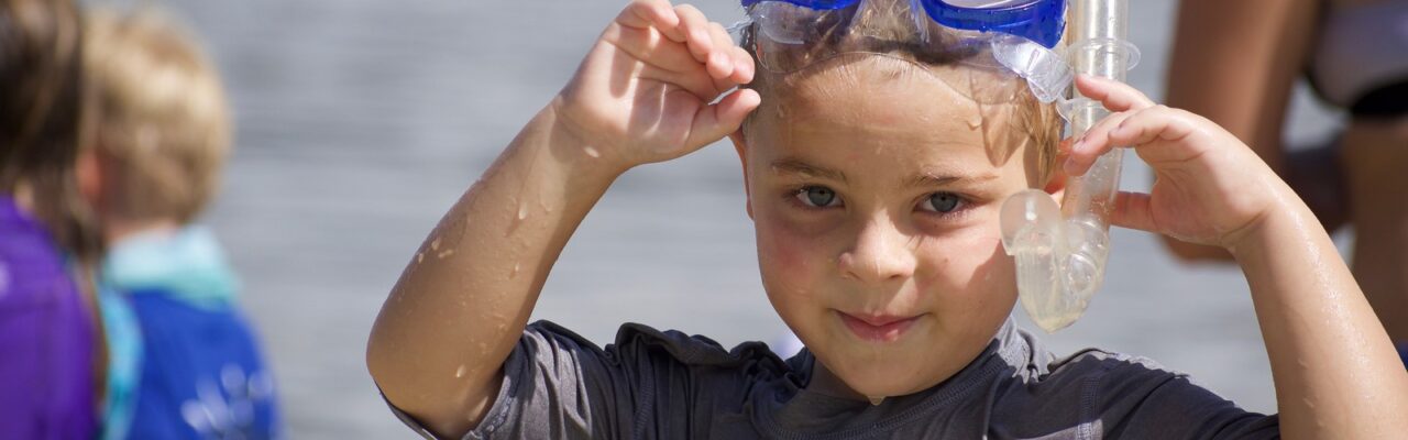 kid in snorkel and mask on beach sanibel sea school