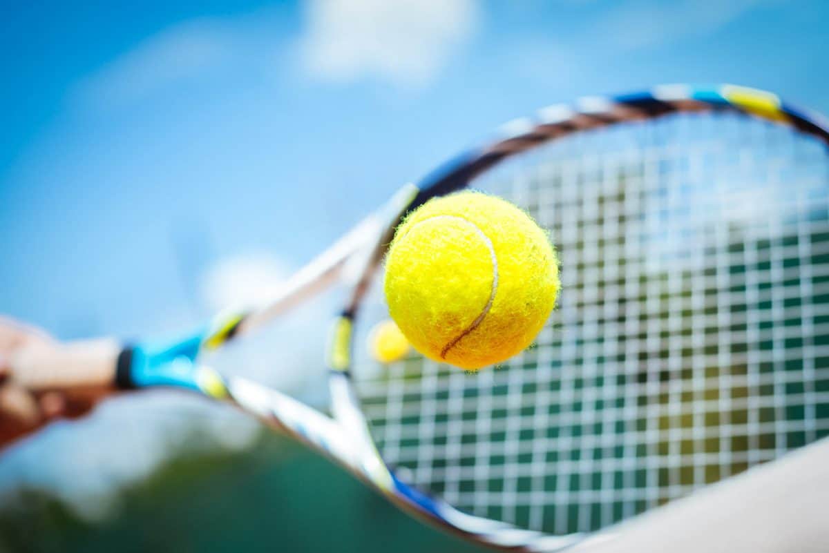 tennis ball hitting racket blue sky sanibel tennis courts sundial