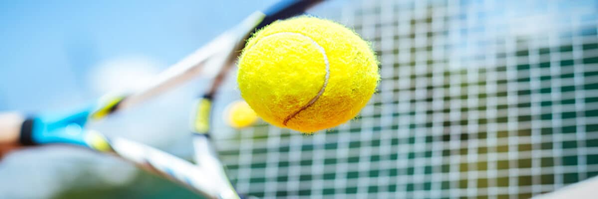 tennis ball hitting racket zoom stock