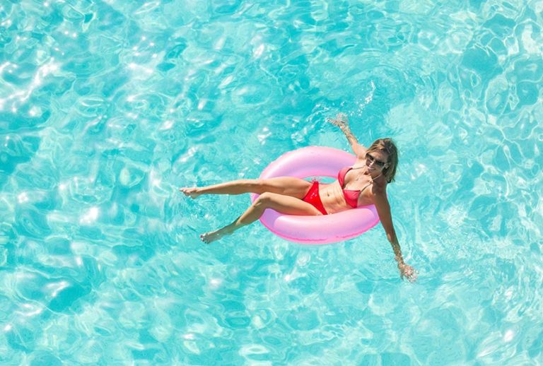 girls getaway package woman floating in pool