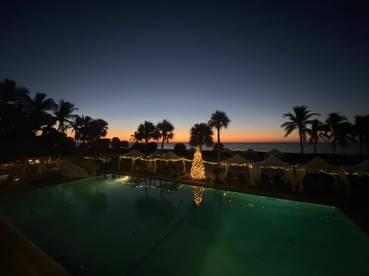 sundial christmas tree by pool light at night sunset