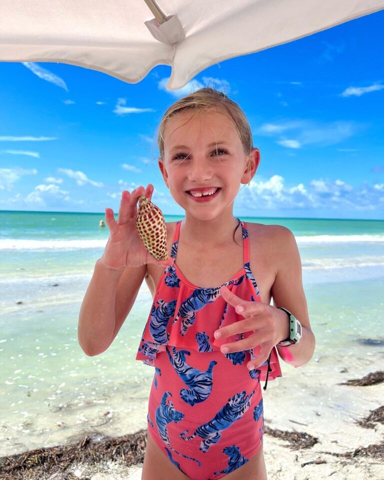 young girl finds large junonia at sundial sanibel