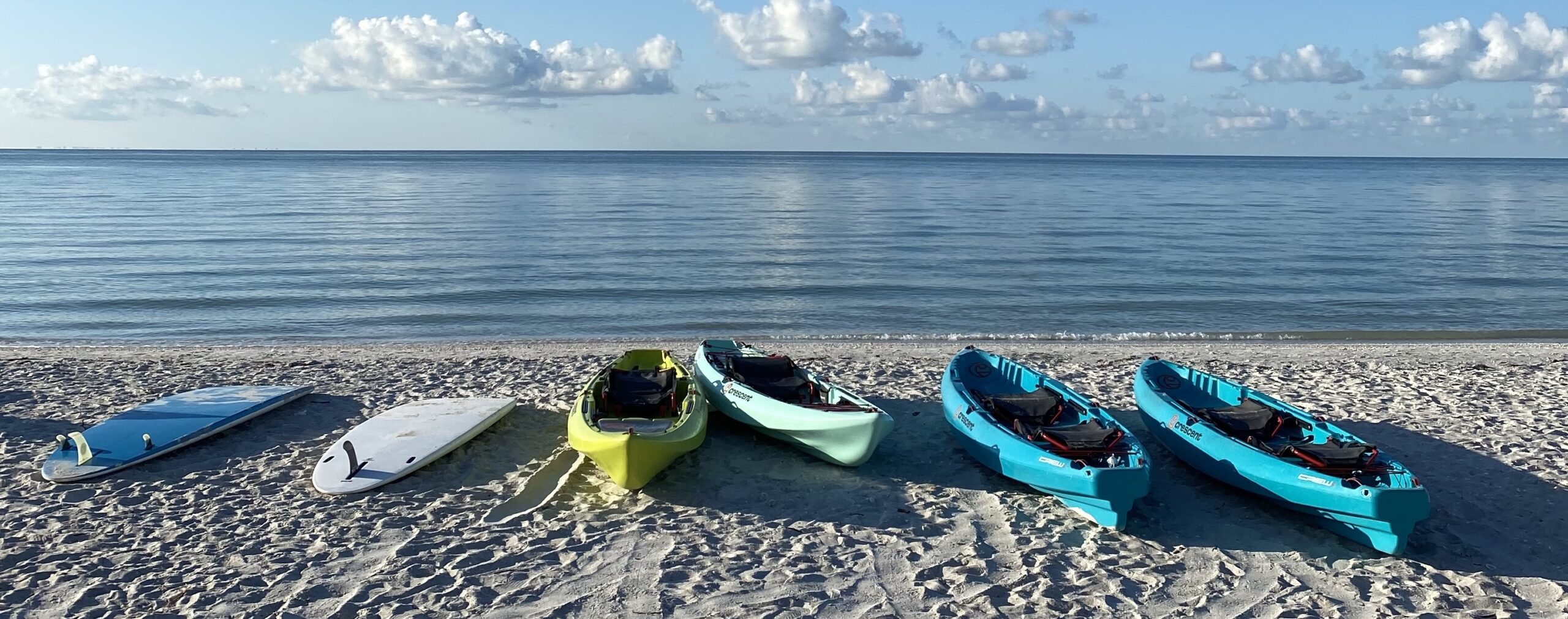 kayakas paddleboards on beach suundial sanibel gulf of mexico