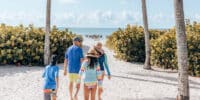 family walking beach path toward beach gulf sanibel island