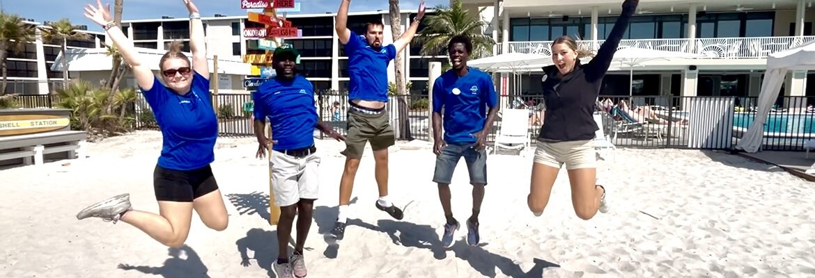 rec team group photo jumping on beach sundial resort