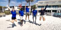 rec team group photo jumping on beach sundial resort