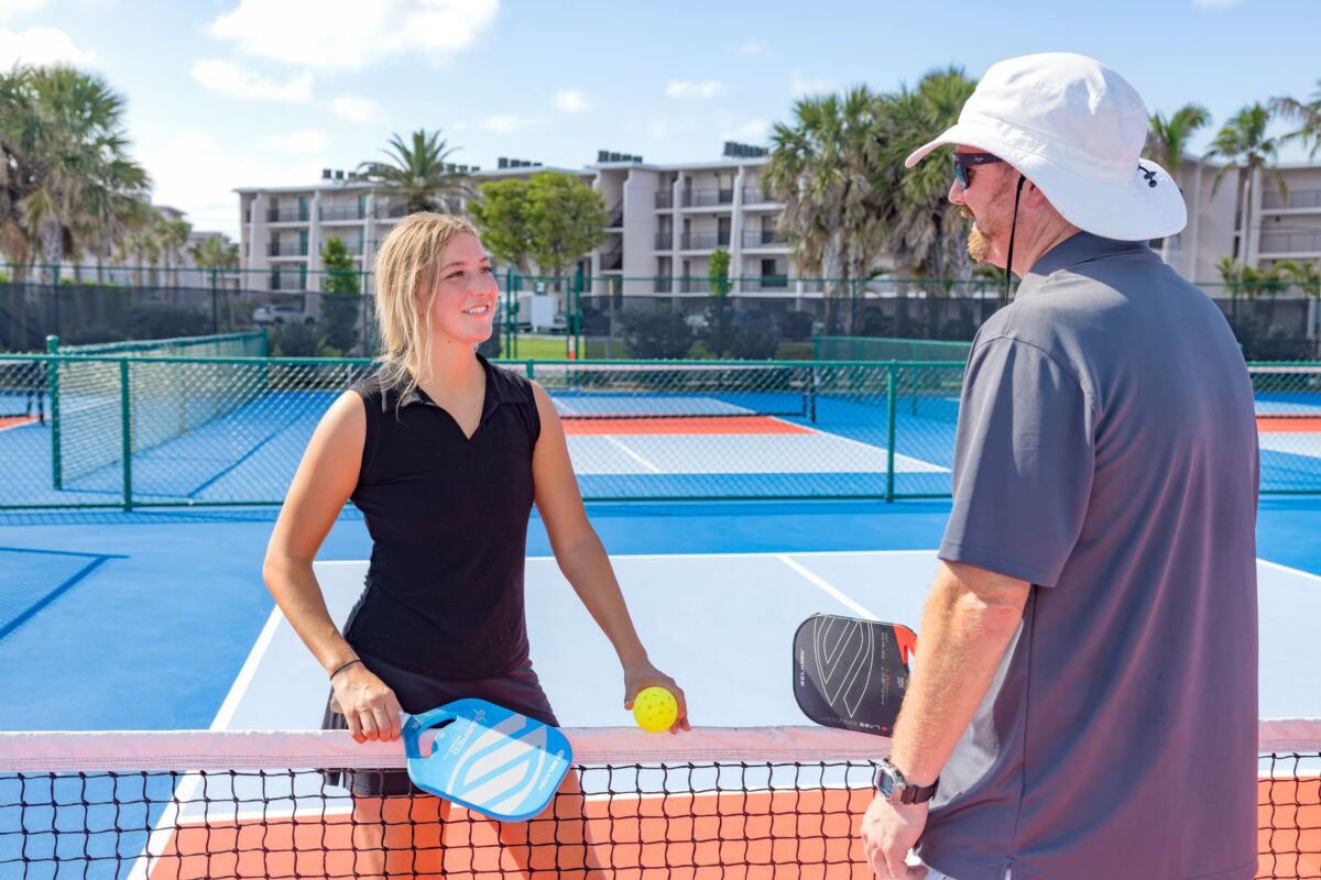 female pickleball plater with instructor at net sundial beach resort and spa sanibel island