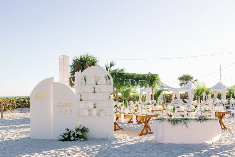beach wedding set up with white chairs and altar and welcome sign at entranc eof aisle sundial resort sanibel island