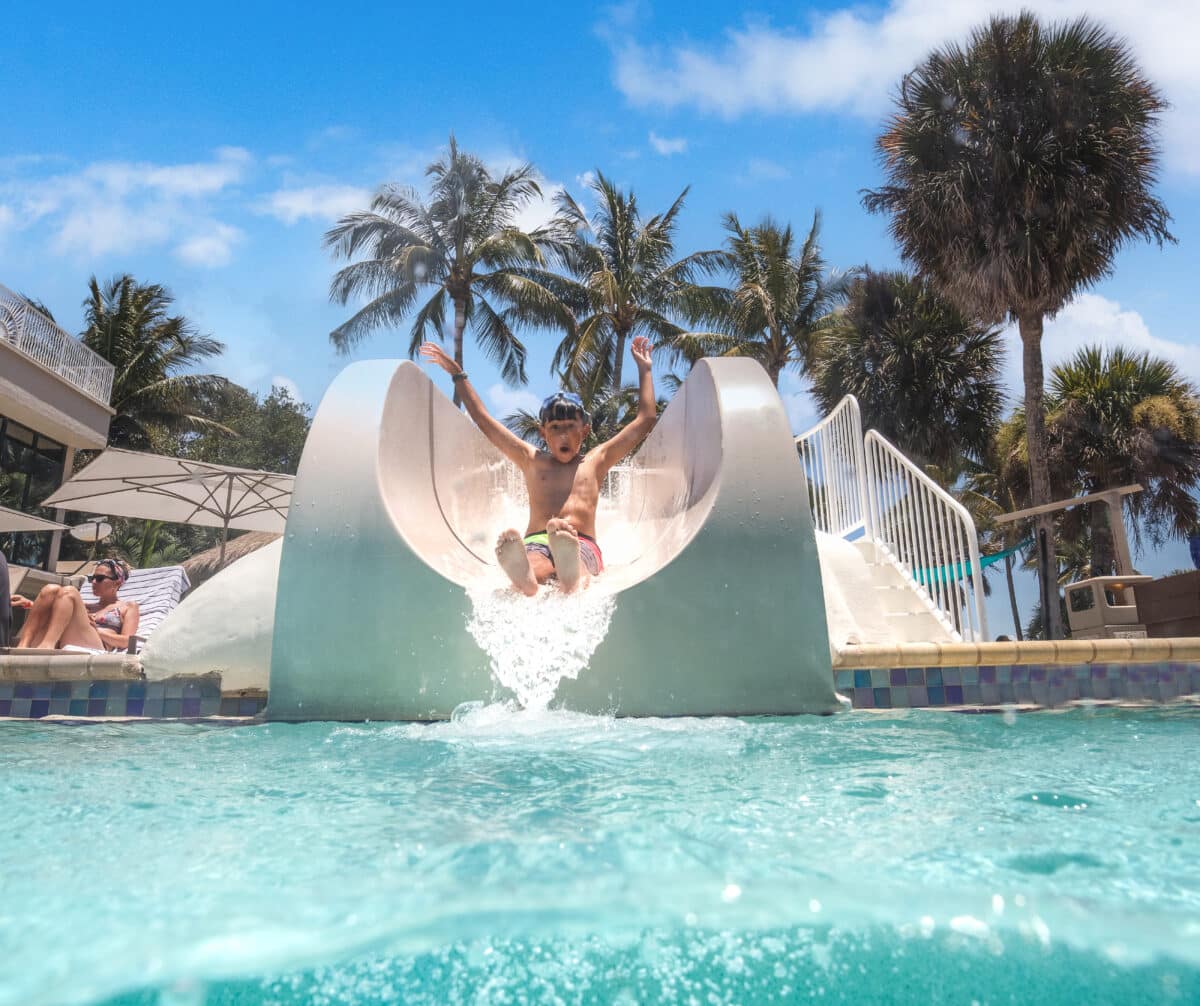 young boy going down slide at sundial resort sanibel island