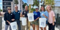 sccf beach bucket station at Sundial with staff posing