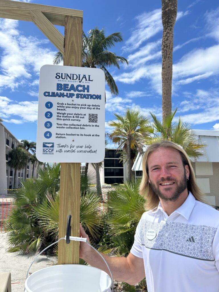staff standing with sccf beach bucket station at Sundial