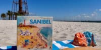 new sanibel board game in front of sanibel lighthouse