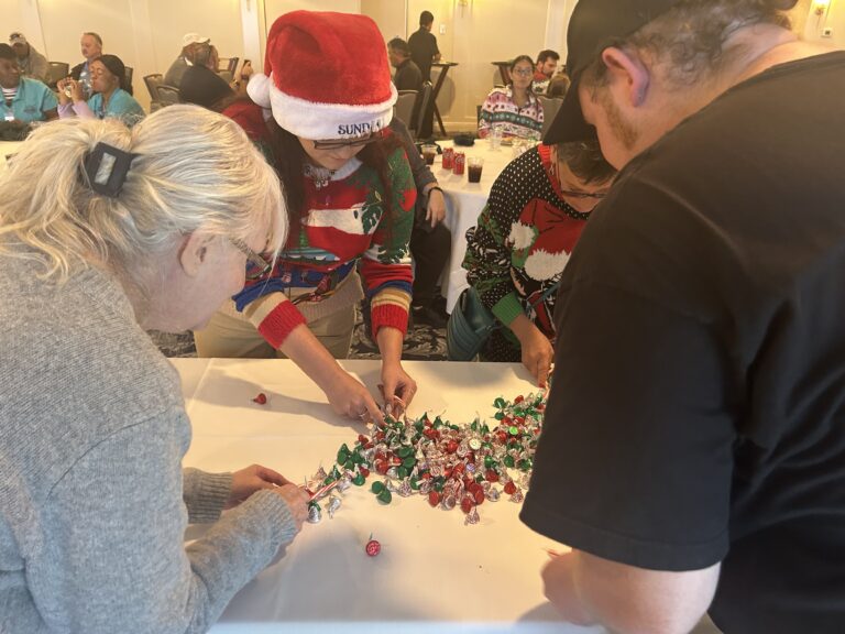 sundial staff at employee holiday party playing game with hershey kisses and candy canes