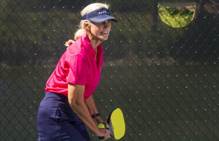woman in pink playing pickleball sundial resort