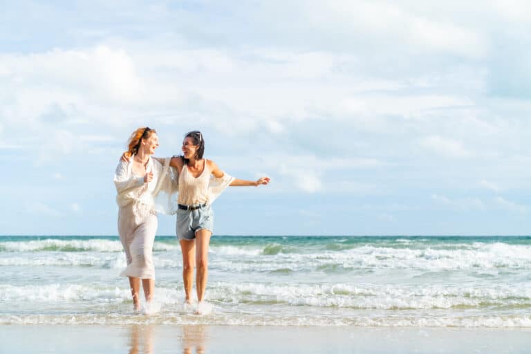 two women enjoying the beach together