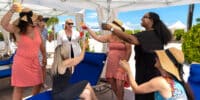 GirlsTripImage women toasting under a cabana