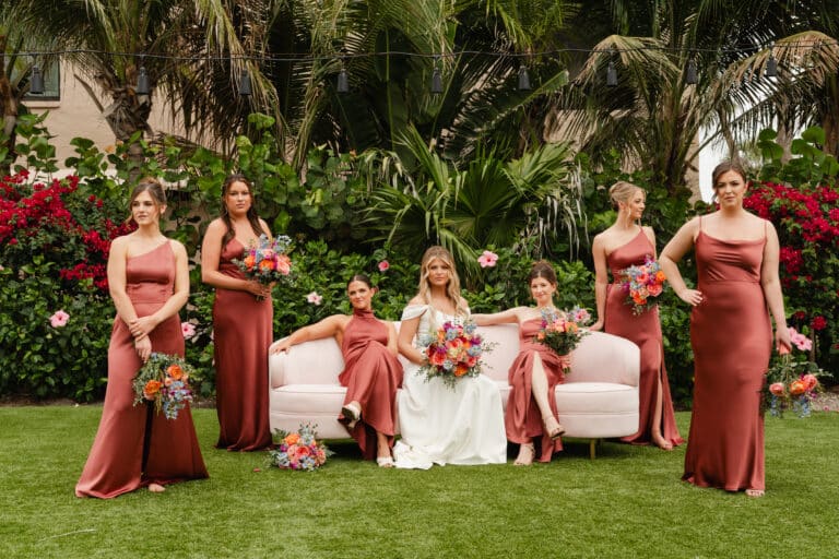 hannah and joey wedding by waking dreams films sundial resort sanibel island bridal party posed around couch with florwers