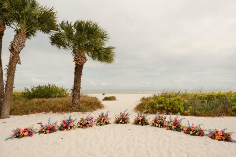 hannah and joey wedding by waking dreams films sundial resort sanibel island bridal party bouquets on beach overlooking gulf of mexico