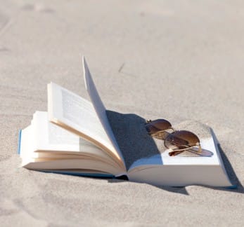 beach reading book in sand